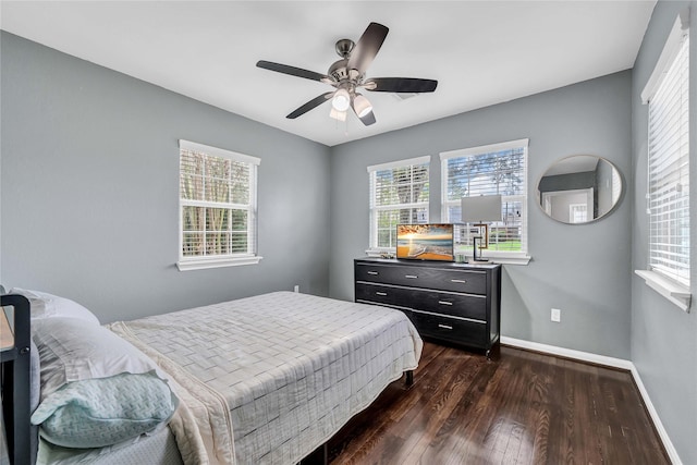 bedroom with dark hardwood / wood-style flooring and ceiling fan