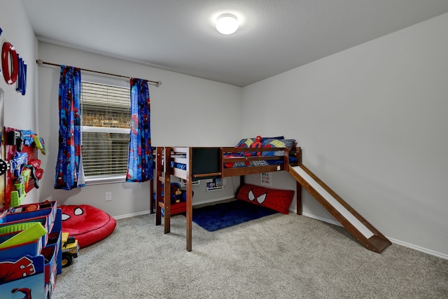 bedroom with carpet floors and baseboards