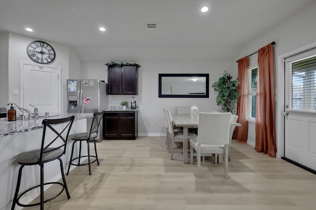 dining space featuring visible vents, recessed lighting, light wood finished floors, and vaulted ceiling