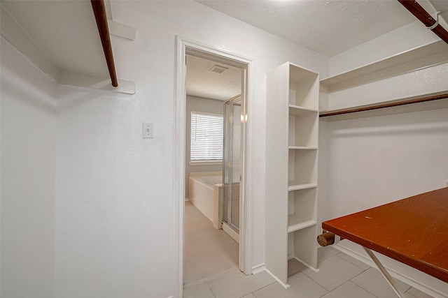 spacious closet featuring visible vents