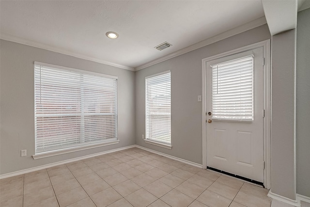 foyer featuring visible vents, light tile patterned floors, baseboards, and crown molding