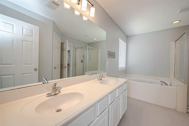 bathroom featuring a sink, visible vents, a bath, and a stall shower