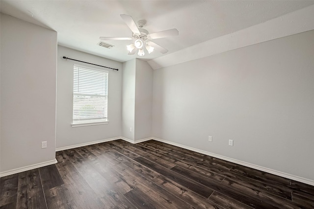 empty room with ceiling fan, visible vents, baseboards, dark wood-style flooring, and lofted ceiling