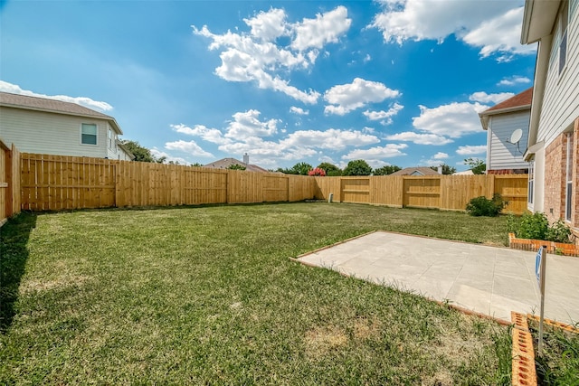 view of yard featuring a patio area and a fenced backyard