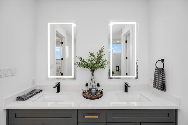 full bathroom with a sink and double vanity