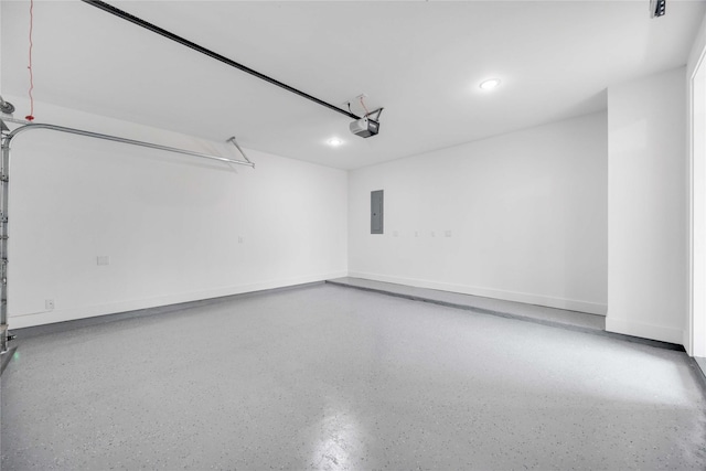 garage featuring electric panel, baseboards, and a garage door opener