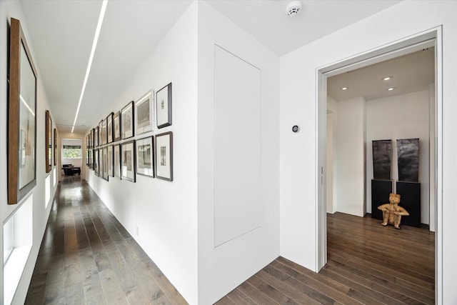 hall with dark wood-style floors and recessed lighting