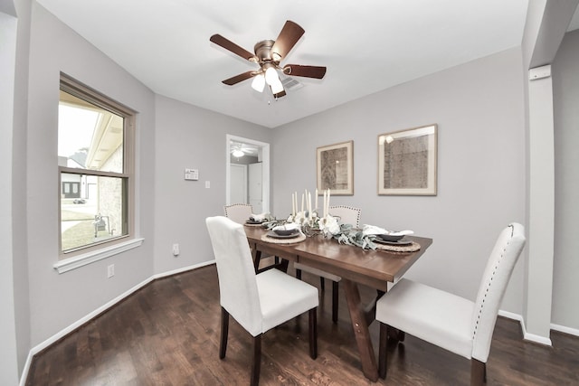 dining room with a ceiling fan, baseboards, and dark wood-type flooring