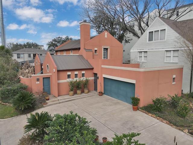 view of front of property featuring stucco siding, an attached garage, and concrete driveway