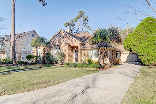 view of front of home with brick siding, a front yard, a garage, and a chimney