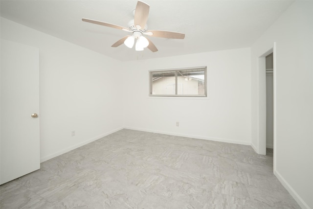 unfurnished bedroom featuring a ceiling fan, baseboards, and a closet