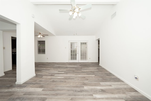 unfurnished room with a ceiling fan, light wood-style flooring, french doors, visible vents, and lofted ceiling