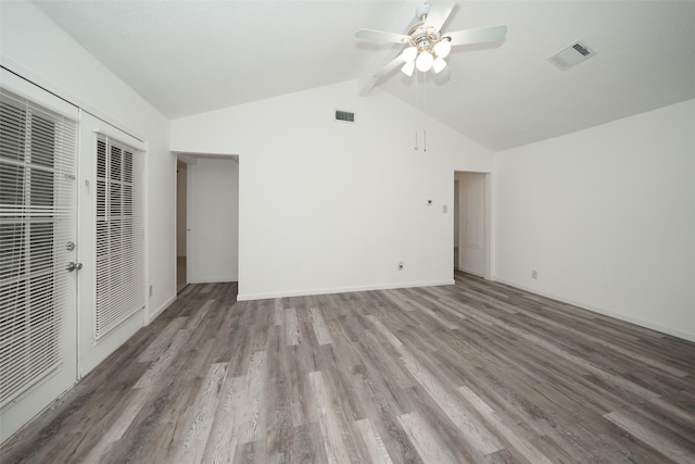 unfurnished room with lofted ceiling with beams, ceiling fan, visible vents, and wood finished floors