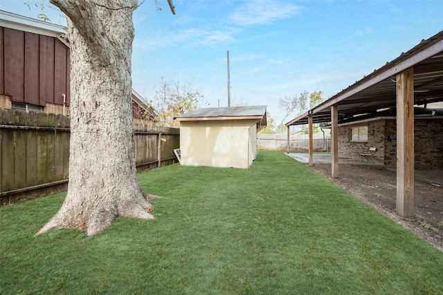 view of yard featuring a storage shed, an outbuilding, and a fenced backyard