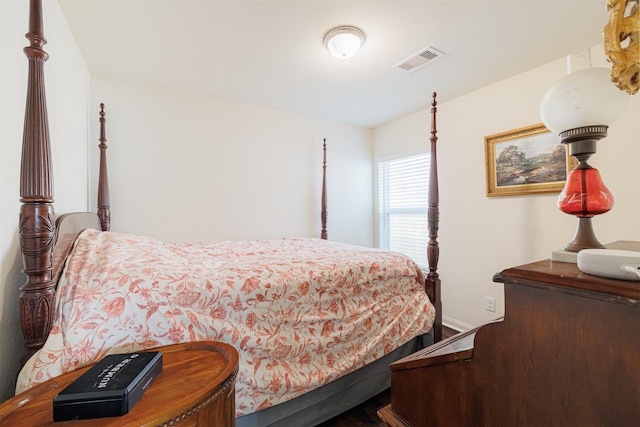 bedroom with baseboards and visible vents