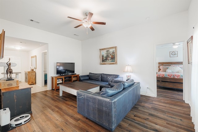 living room with dark wood finished floors, ceiling fan, and visible vents