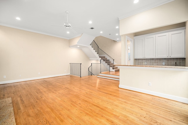 unfurnished living room with ornamental molding, visible vents, baseboards, light wood-type flooring, and recessed lighting