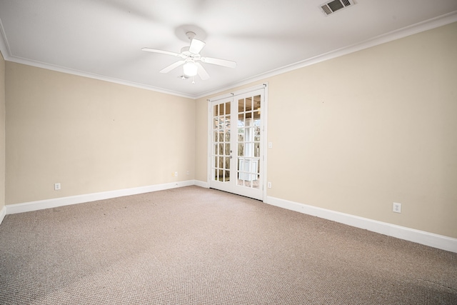 spare room with baseboards, ornamental molding, visible vents, carpet floors, and ceiling fan