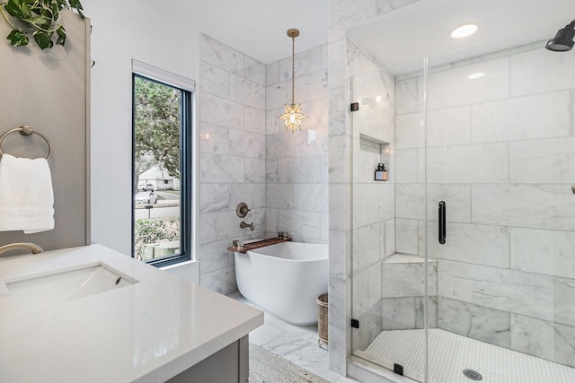 506 Fox Briar Ln, Sugar Land, TX 77478 - bathroom with marble finish floors, vanity, a shower stall, a freestanding tub, and tile walls