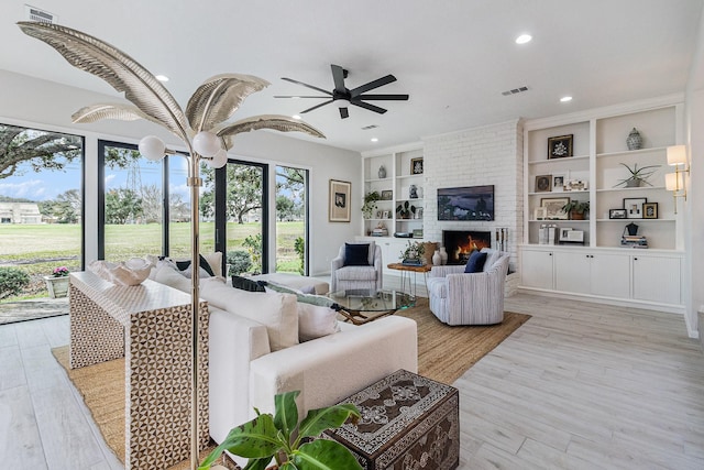 506 Fox Briar Ln, Sugar Land, TX 77478 - living area featuring ceiling fan, recessed lighting, built in features, light wood-style flooring, and a fireplace