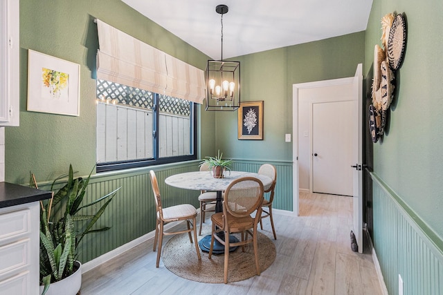 506 Fox Briar Ln, Sugar Land, TX 77478 - dining area featuring light wood finished floors, a chandelier, a textured wall, and baseboards