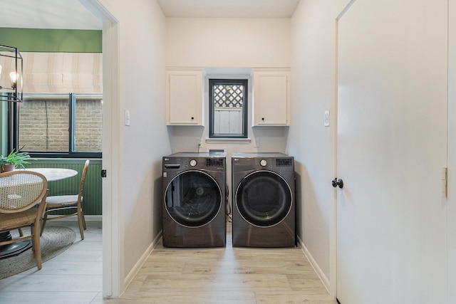506 Fox Briar Ln, Sugar Land, TX 77478 - laundry area featuring cabinet space, washing machine and dryer, light wood-style floors, and baseboards