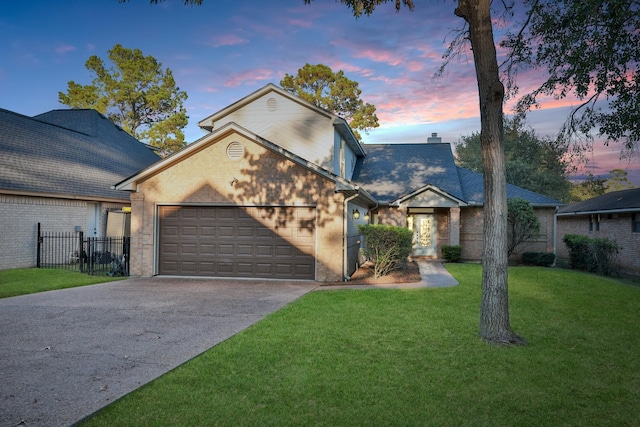 traditional home with concrete driveway, a front lawn, a chimney, an attached garage, and fence