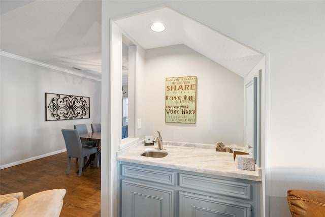 bar featuring a sink, baseboards, recessed lighting, and dark wood-type flooring