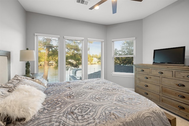 bedroom featuring access to exterior, ceiling fan, and visible vents