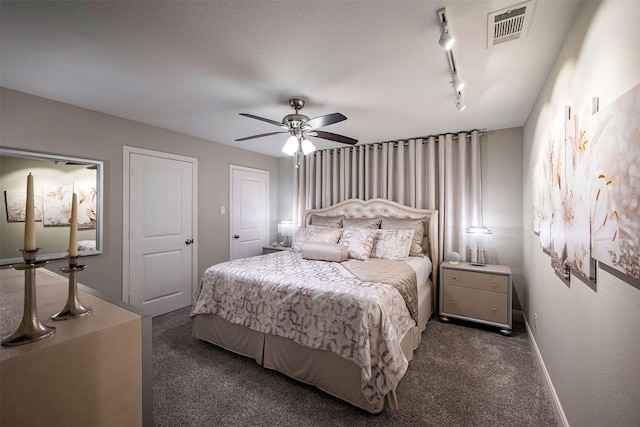 bedroom featuring visible vents, a ceiling fan, baseboards, dark colored carpet, and track lighting