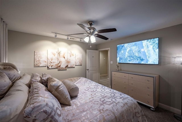 bedroom featuring carpet flooring, baseboards, a ceiling fan, and track lighting