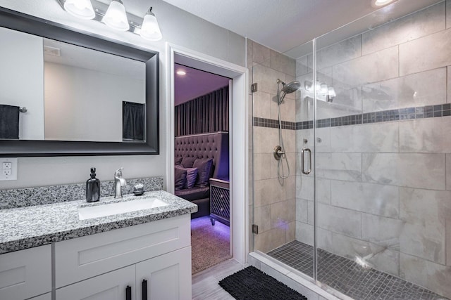 full bathroom with vanity, visible vents, and a stall shower