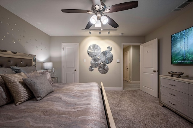 bedroom with baseboards, visible vents, light carpet, and ceiling fan