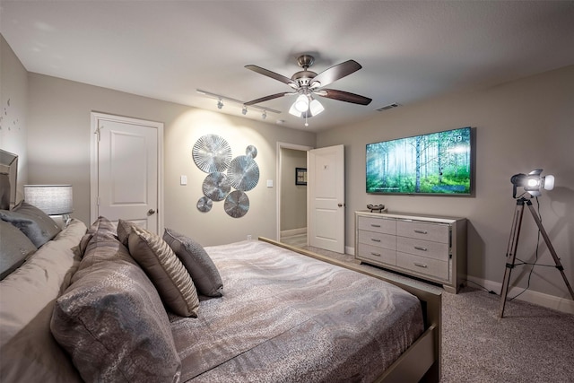 bedroom with a ceiling fan, visible vents, baseboards, and carpet flooring