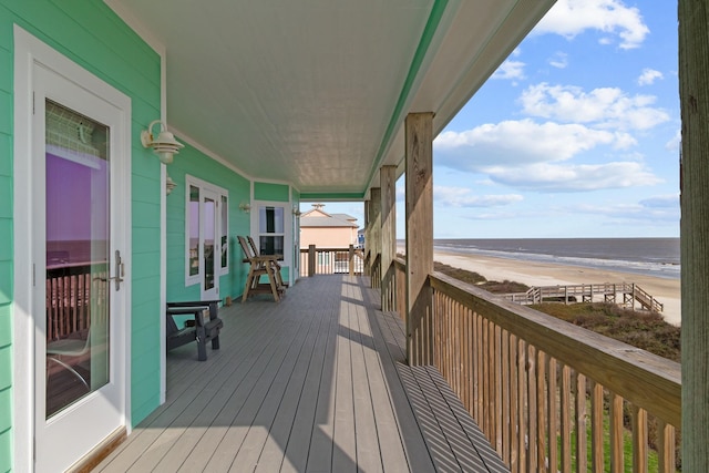 deck with a water view and a beach view