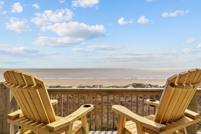 exterior space featuring a water view and a beach view