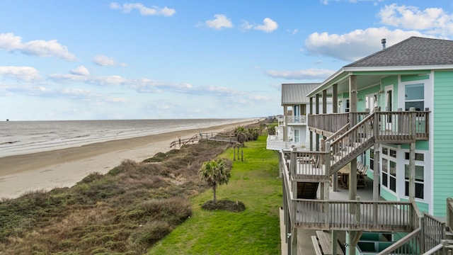 view of water feature with stairs and a beach view