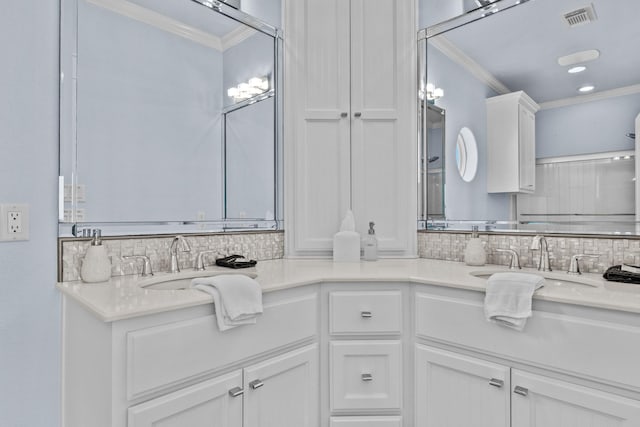 full bath featuring a sink, visible vents, and crown molding