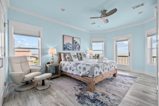 bedroom featuring access to exterior, visible vents, and ornamental molding