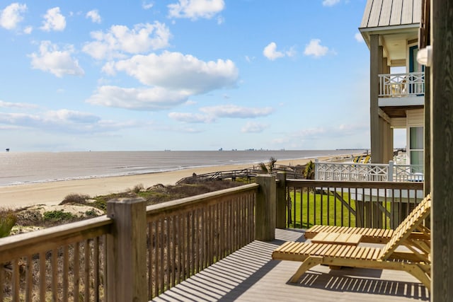 wooden terrace with a water view and a beach view