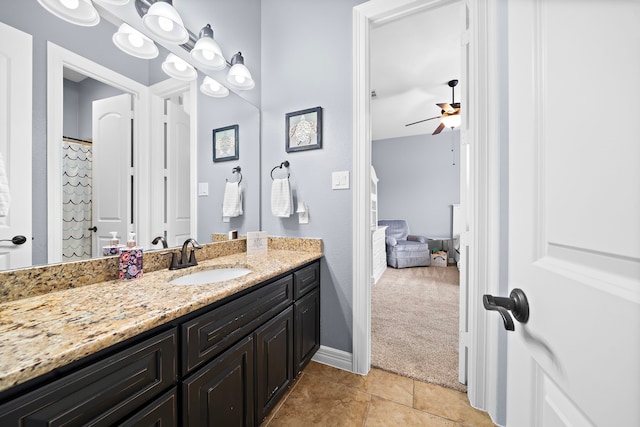 bathroom featuring baseboards, vanity, ceiling fan, and tile patterned flooring