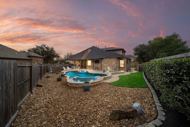 view of pool featuring a fenced in pool, a fenced backyard, an in ground hot tub, and a patio area