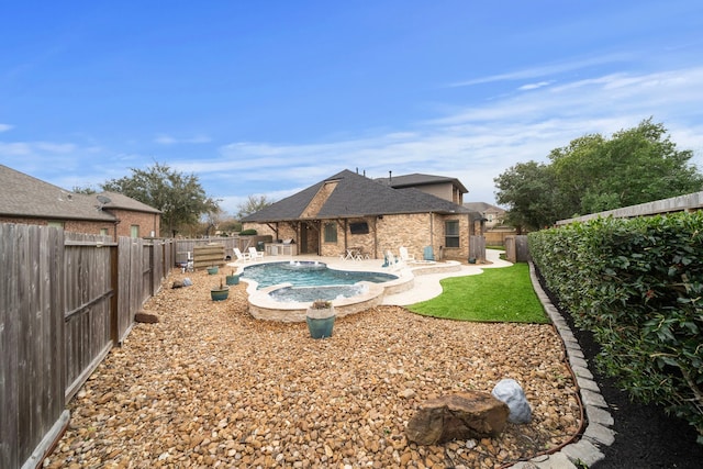 view of pool featuring a patio area, a jacuzzi, a fenced backyard, and a fenced in pool