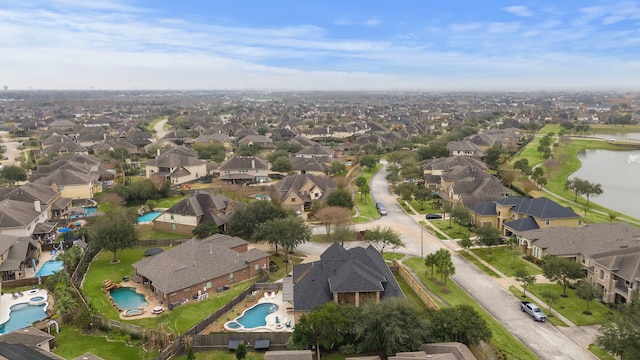 bird's eye view with a water view and a residential view