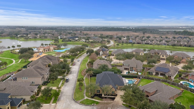 birds eye view of property featuring a water view and a residential view