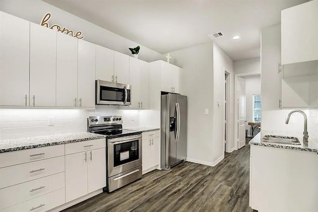 kitchen featuring visible vents, white cabinetry, and appliances with stainless steel finishes