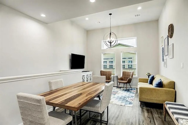 interior space featuring recessed lighting, visible vents, an inviting chandelier, and wood finished floors