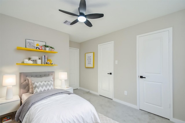 bedroom featuring baseboards, ceiling fan, and light carpet