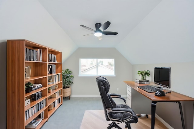 home office featuring light colored carpet, a ceiling fan, baseboards, and lofted ceiling