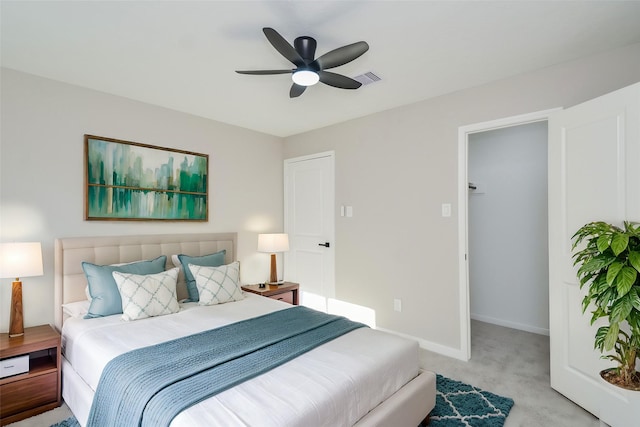 bedroom featuring baseboards, visible vents, light colored carpet, and ceiling fan